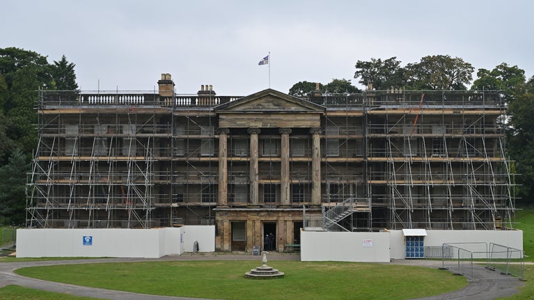Landscape image of the front of the house in scaffolding